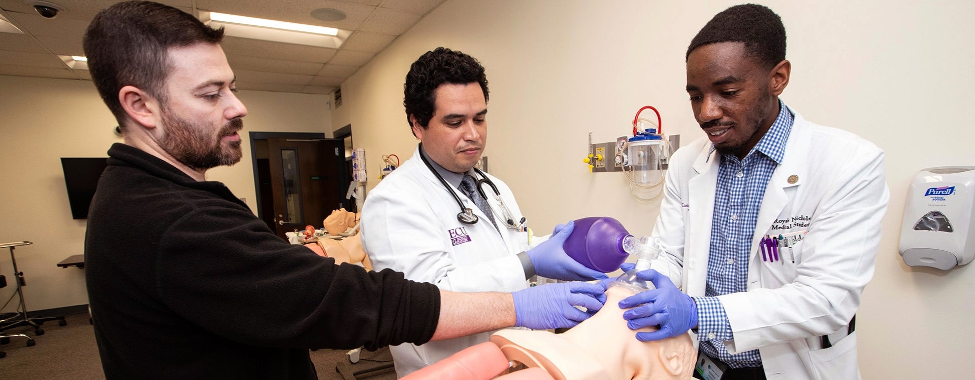 Medical students from the Brody School of Medicine work with an instructor to learn resuscitation techniques.