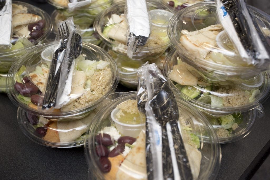 Closeup of boxed lunches with disposable utensils on top