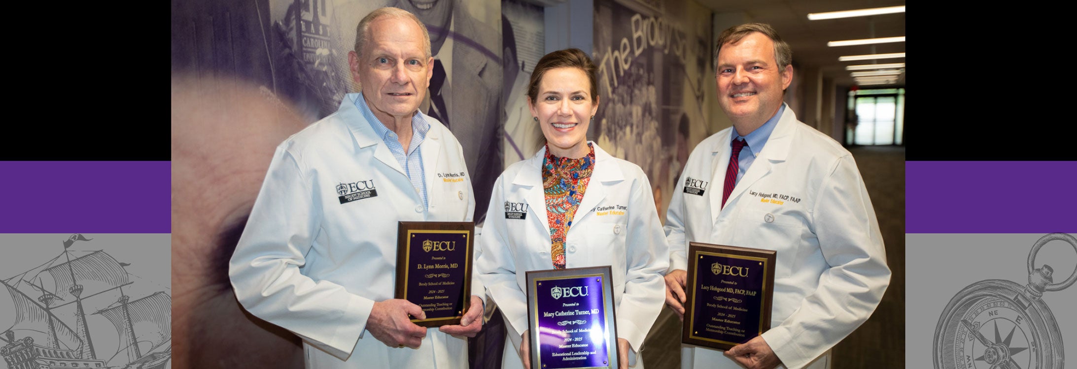 Three ECU medical faculty members in white coats holding Master Educator Awards, standing in a hallway with ECU-themed murals in the background.